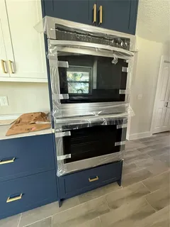 a kitchen with a sink stove and cabinets