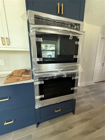 a kitchen with a sink stove and cabinets