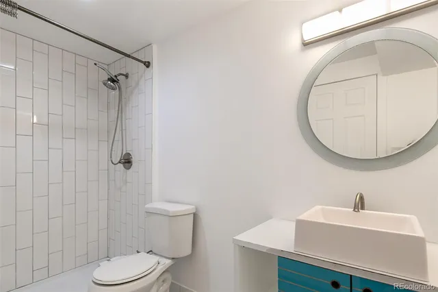 a bathroom with a sink a mirror and a toilet