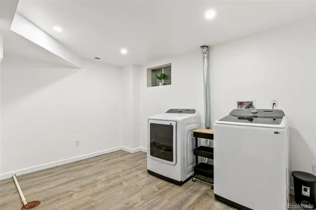 a view of washer and dryer with wooden floor