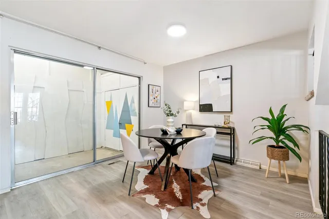a view of a livingroom with furniture and hardwood floor