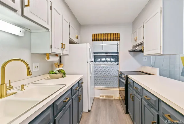 a kitchen with a sink a stove and refrigerator