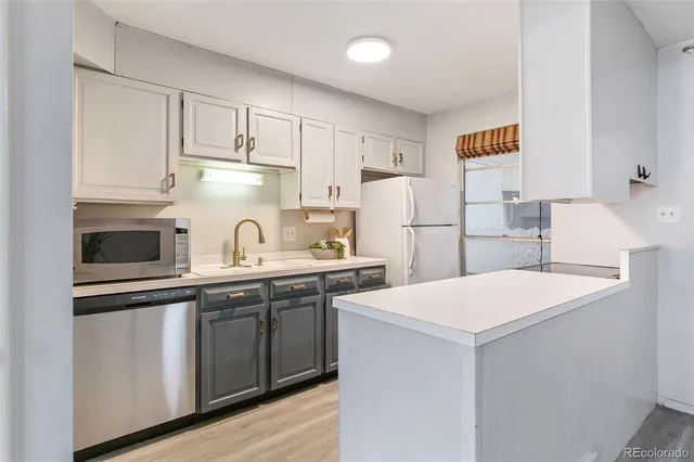 a kitchen with stainless steel appliances a sink and a refrigerator