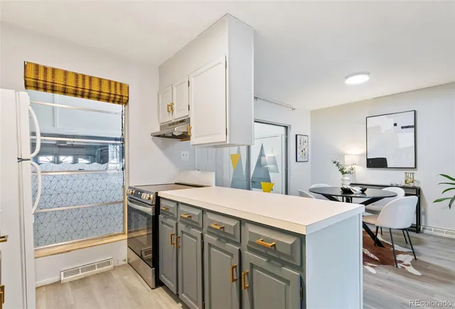 a kitchen that has a sink and a stove in it