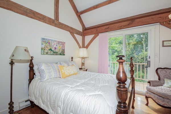 37 Wedgewood Road Stow, MA 01775 - Photo 19 of 30 a bedroom with a bed a couch and large window