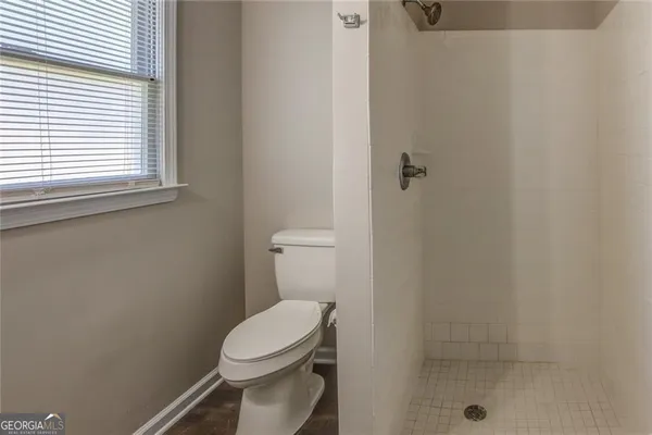 a white toilet sitting next to a bathroom sink