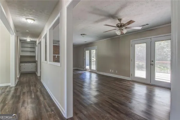 wooden floor in an empty room with a window
