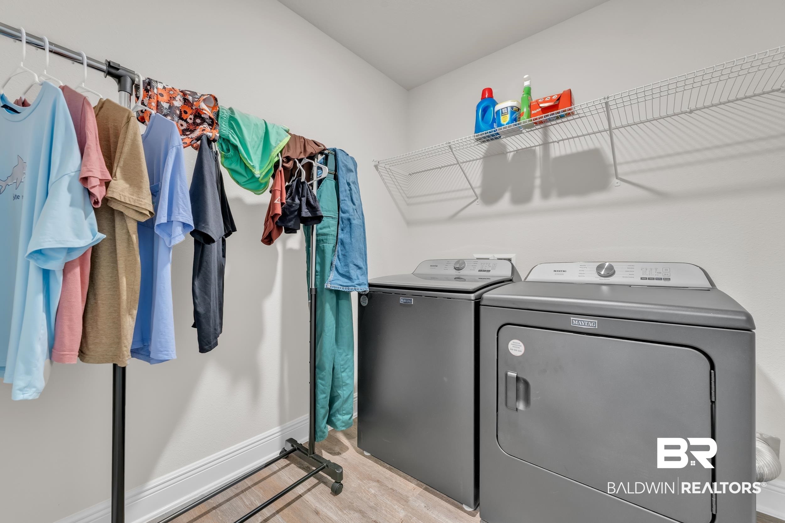 24460 Ringneck Loop Elberta, AL 36530 - Photo 34 of 46 Laundry room featuring washer and clothes dryer, baseboards, light wood-style floors, and laundry area