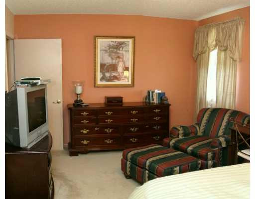 5485 Gate Lake Road, Unit 5485 Tamarac, FL 33319 - Photo 7 of 8 a living room with furniture and a flat screen tv
