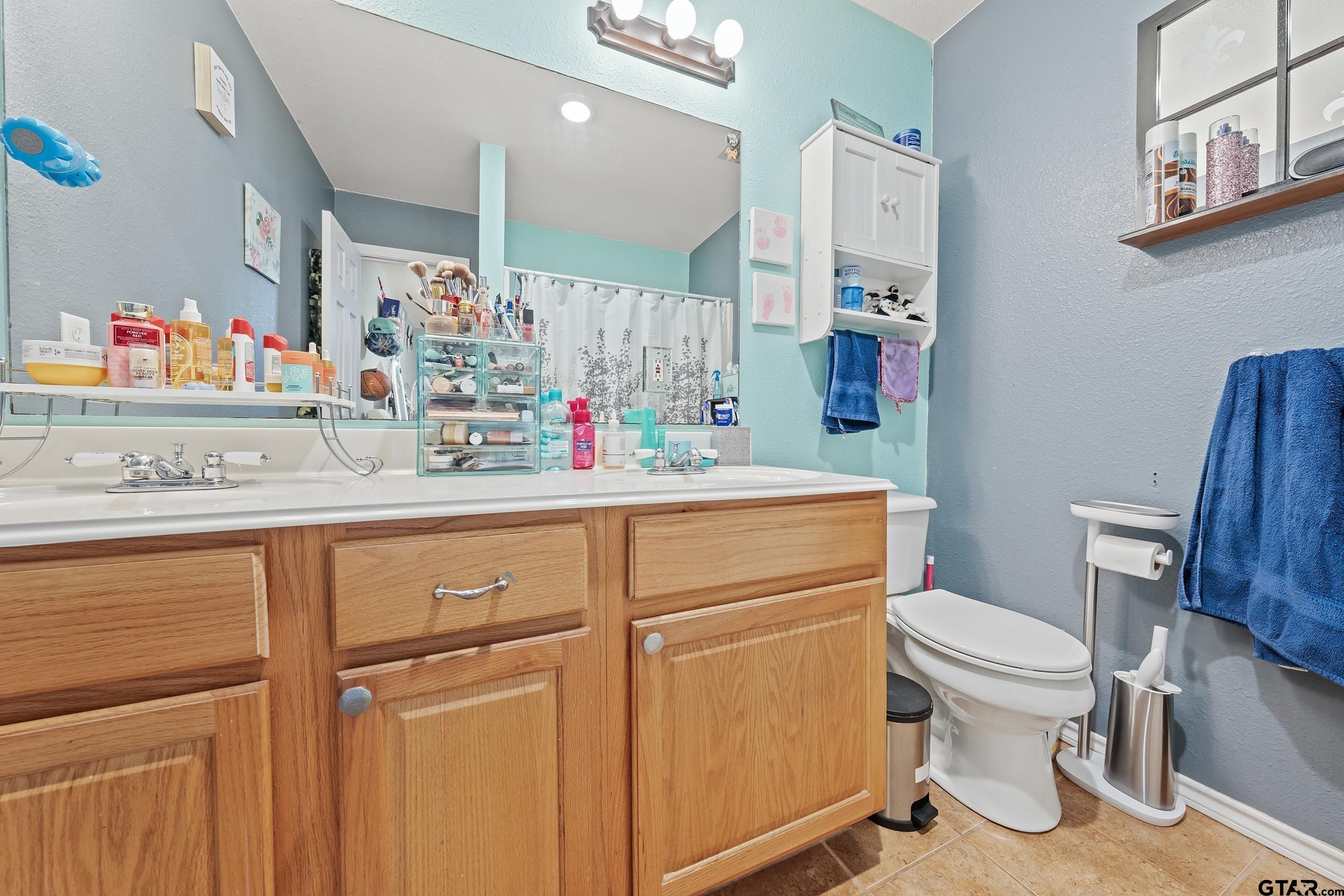 200 David Hawkins, TX 75765 - Photo 20 of 36 a bathroom with a sink toilet vanity and window