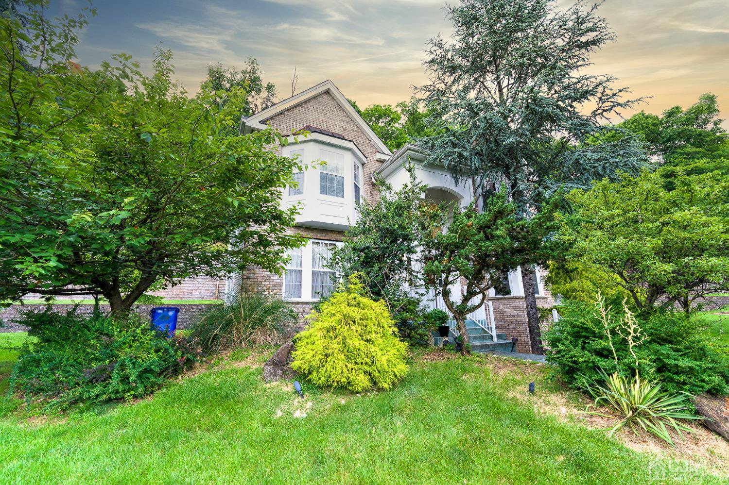 a view of a house with a yard and sitting area