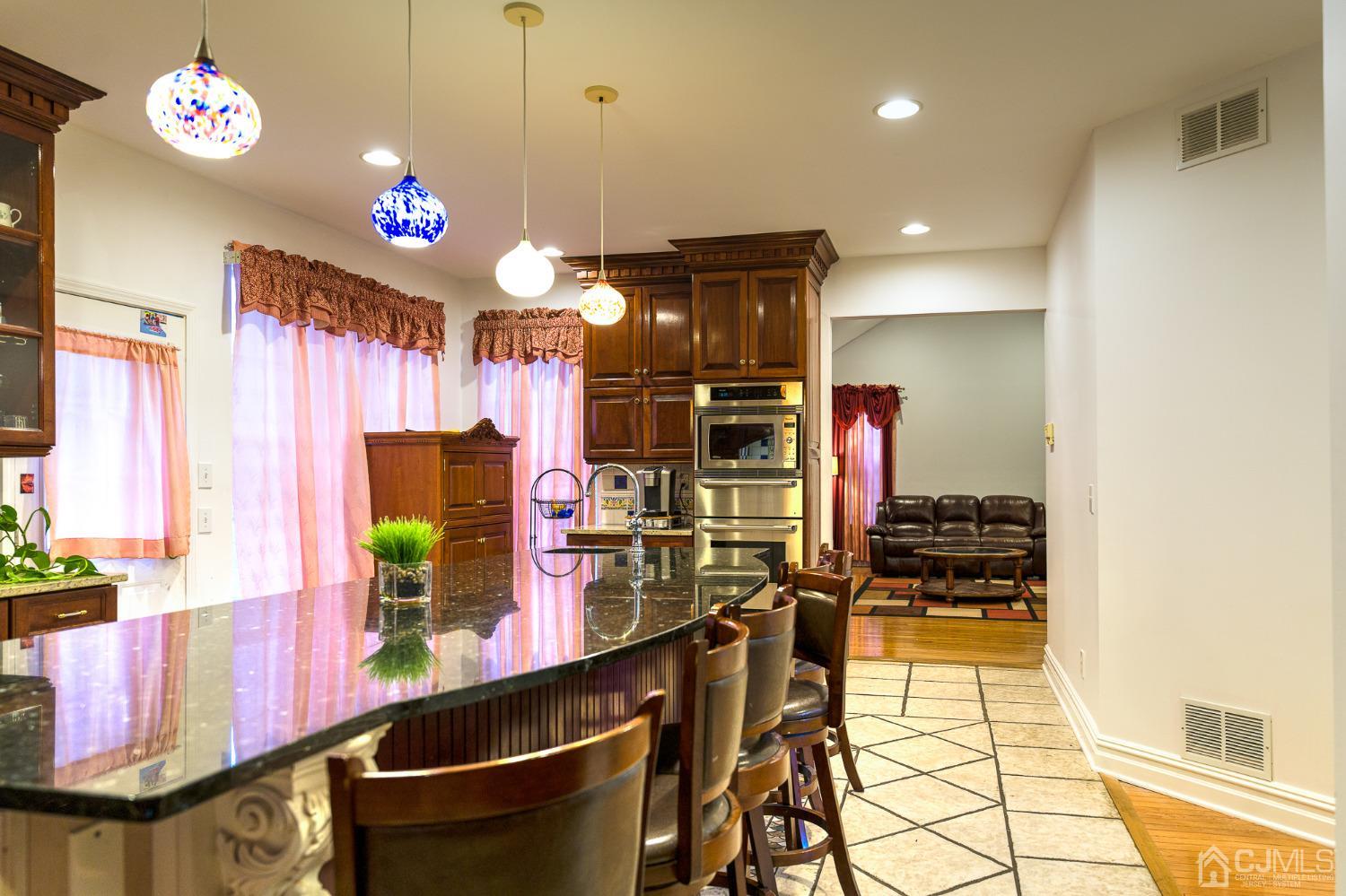 110 Ravine Road Green Brook, NJ 08812 - Photo 11 of 38 a kitchen with stainless steel appliances kitchen island granite countertop a stove a sink and a refrigerator
