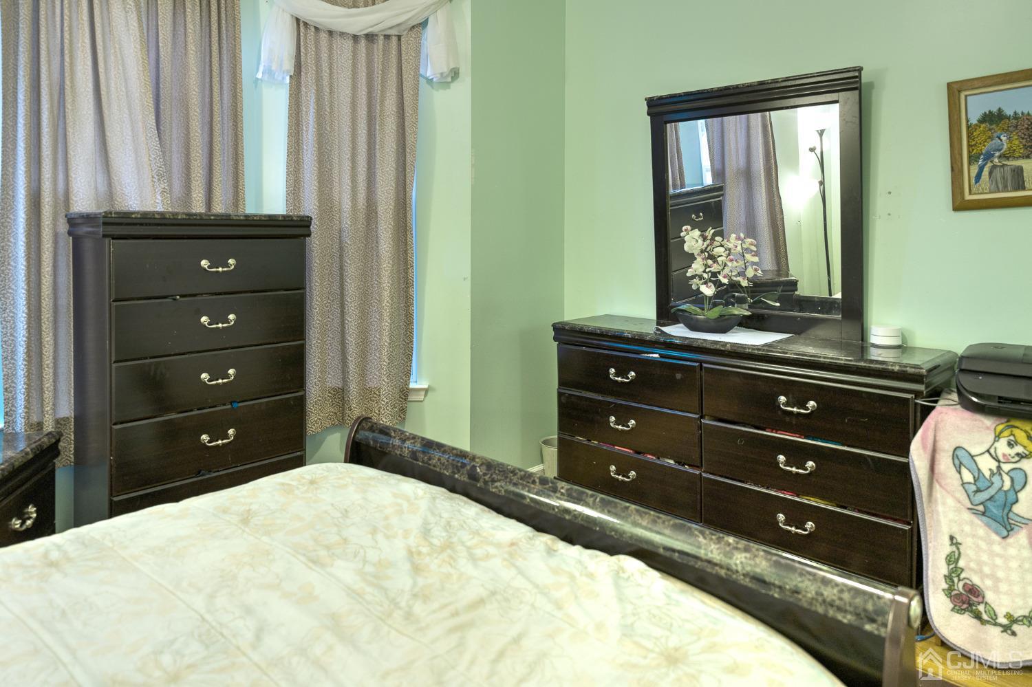 110 Ravine Road Green Brook, NJ 08812 - Photo 16 of 38 a bedroom with a bed and a mirror
