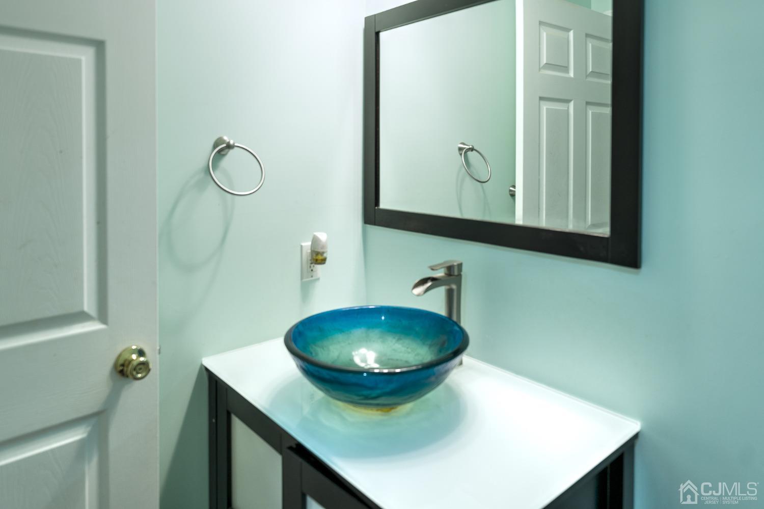 110 Ravine Road Green Brook, NJ 08812 - Photo 19 of 38 a bathroom with a sink a mirror and vanity