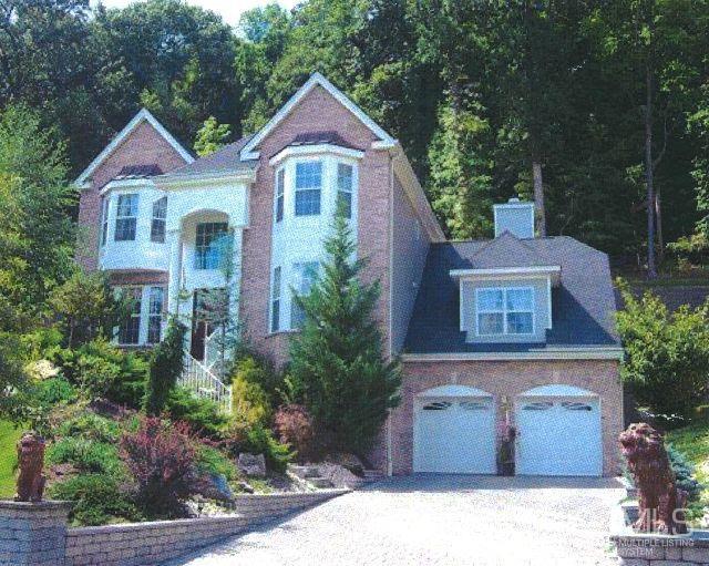 110 Ravine Road Green Brook, NJ 08812 - Photo 2 of 38 a front view of a house with a garden