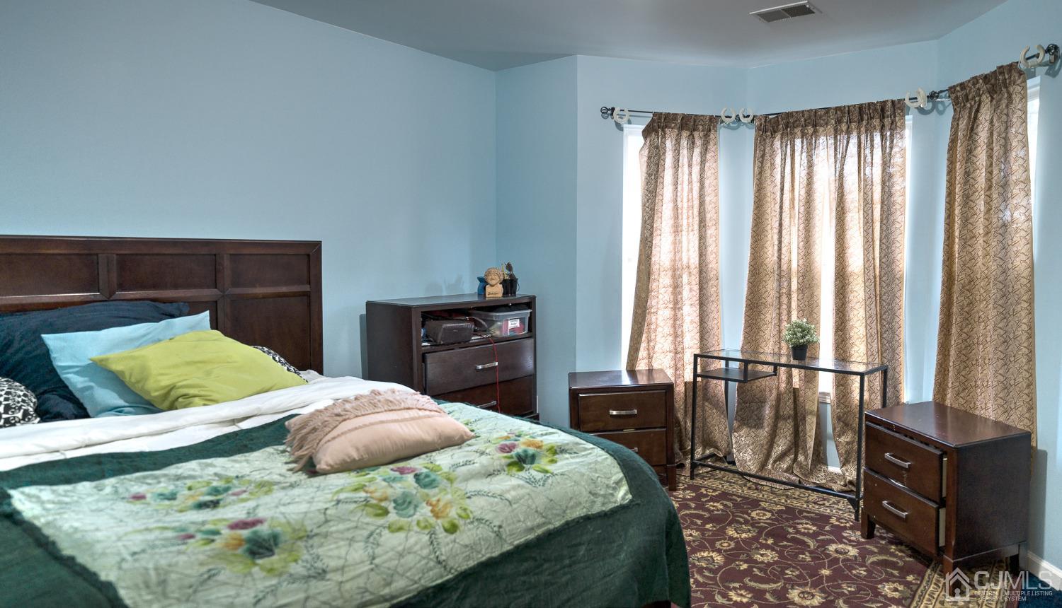 110 Ravine Road Green Brook, NJ 08812 - Photo 21 of 38 a bedroom with a bed and wooden floor