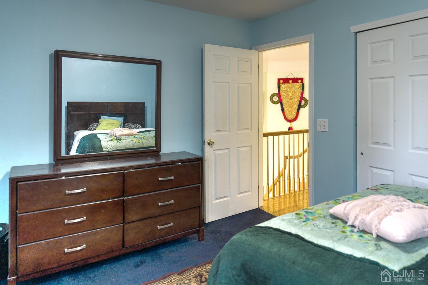 110 Ravine Road Green Brook, NJ 08812 - Photo 22 of 38 a bedroom with a bed and a mirror on the dresser