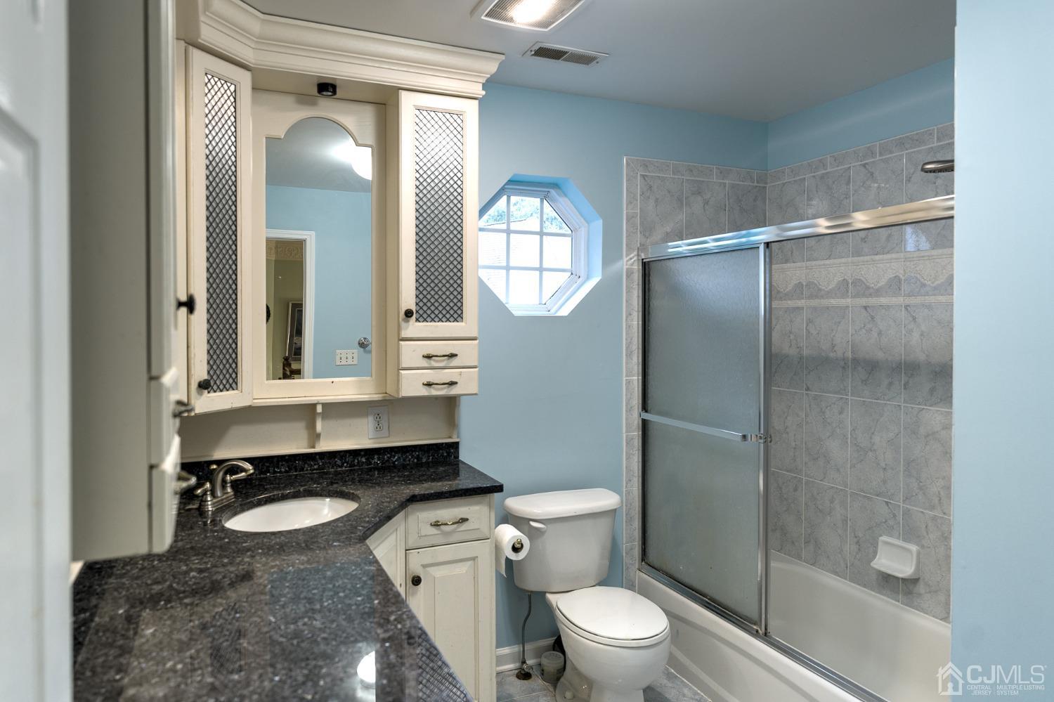 110 Ravine Road Green Brook, NJ 08812 - Photo 23 of 38 a bathroom with a toilet a sink and a mirror