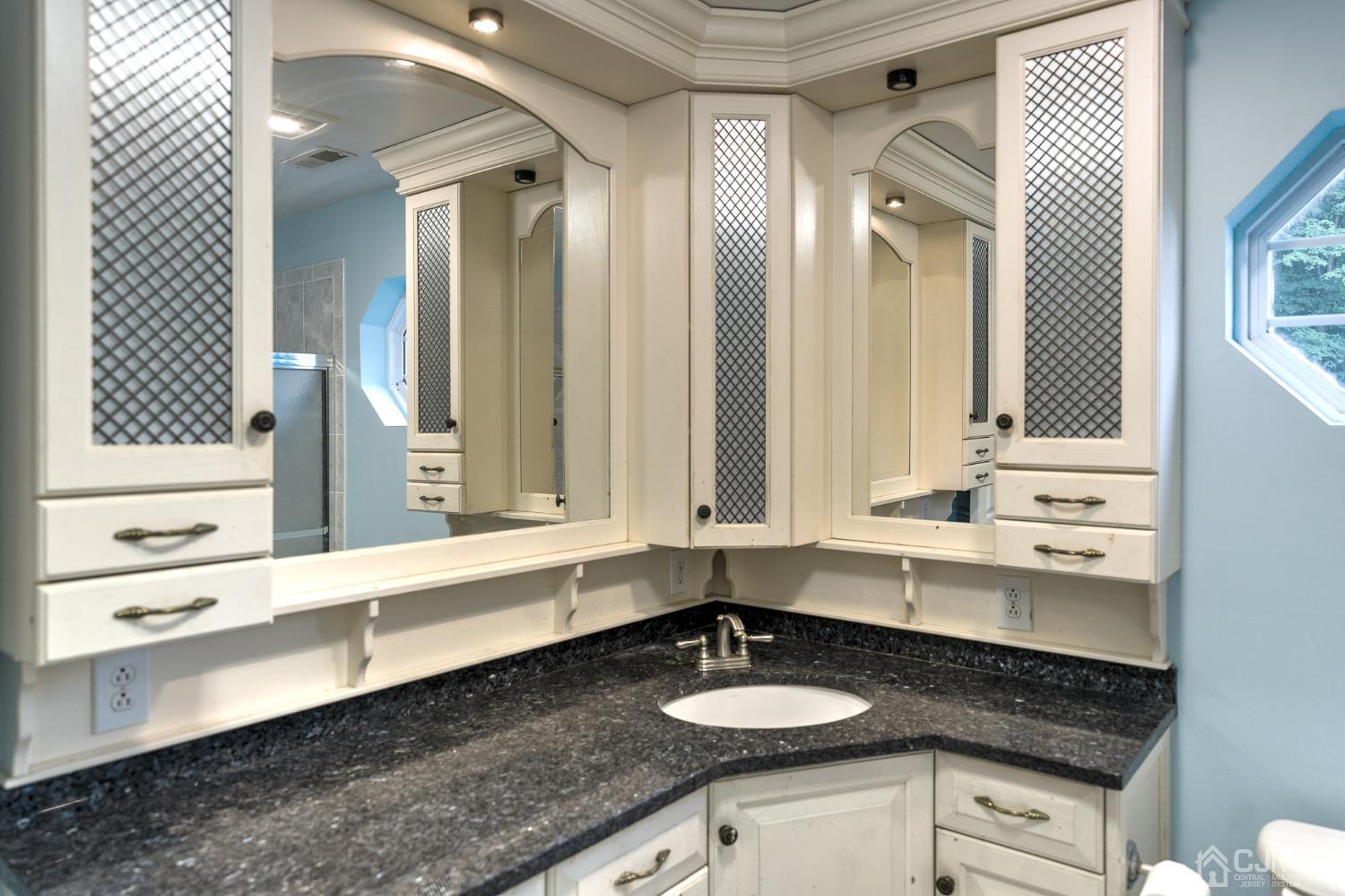 110 Ravine Road Green Brook, NJ 08812 - Photo 24 of 38 a bathroom with a granite countertop sink and a mirror