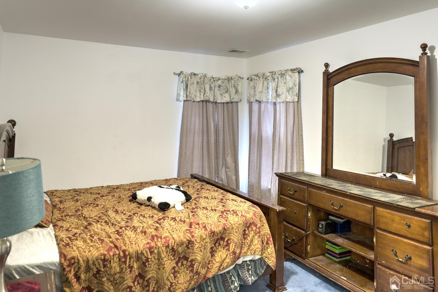 110 Ravine Road Green Brook, NJ 08812 - Photo 27 of 38 a bedroom with a bed and a large mirror on the dresser
