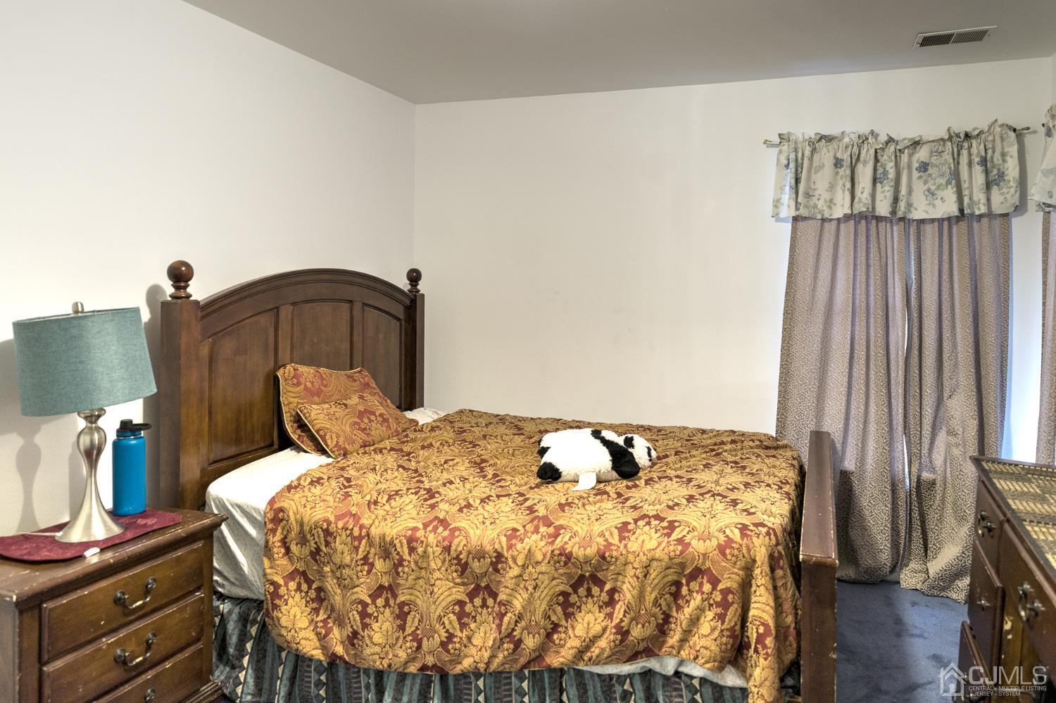 110 Ravine Road Green Brook, NJ 08812 - Photo 28 of 38 a bedroom with a bed and wooden floor