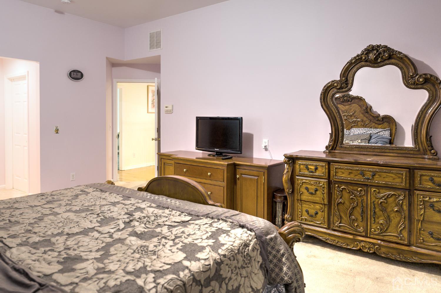 110 Ravine Road Green Brook, NJ 08812 - Photo 29 of 38 a bedroom with a bed and flat screen tv