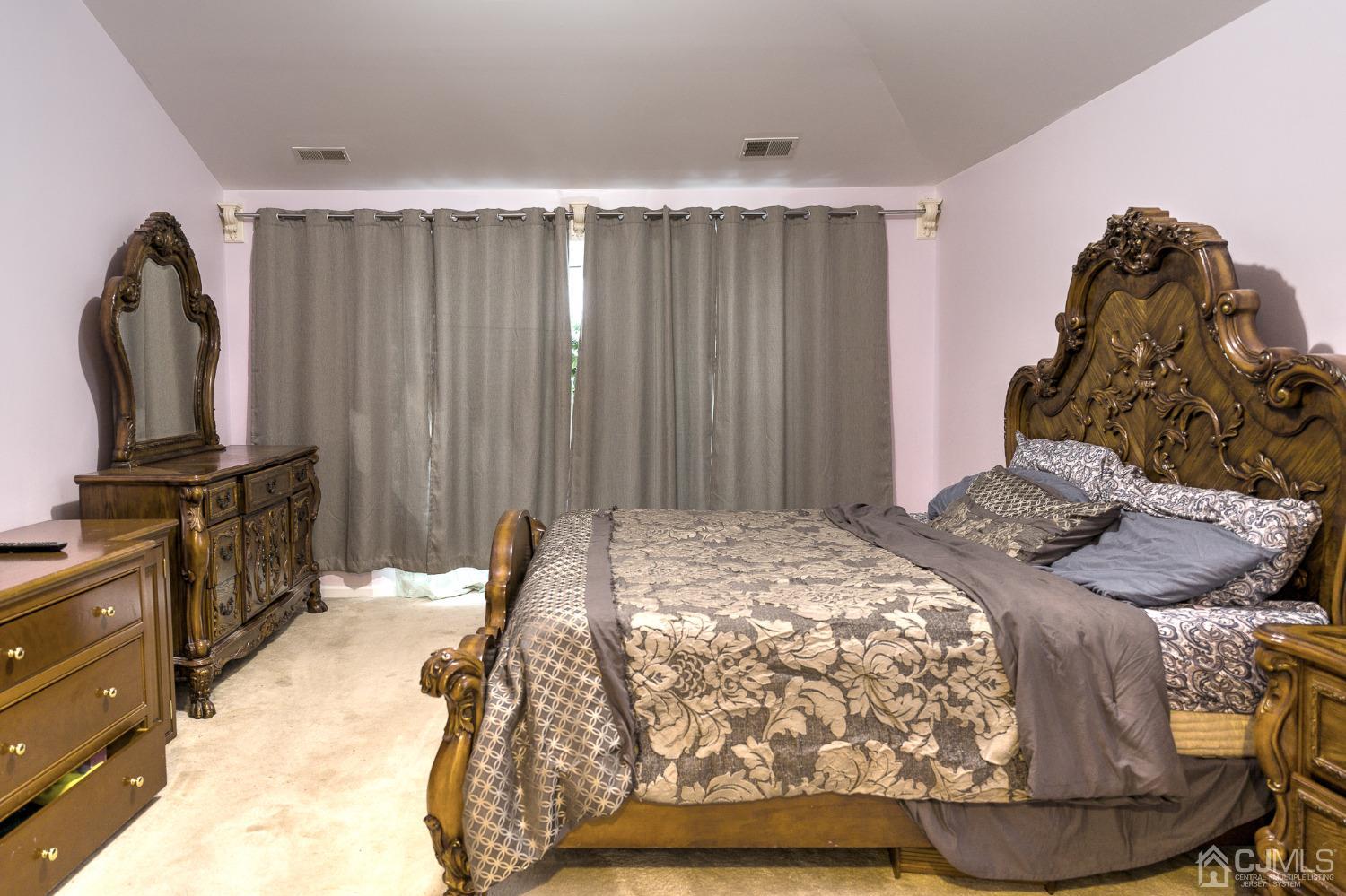 110 Ravine Road Green Brook, NJ 08812 - Photo 30 of 38 a bedroom with a bed and a flat tv screen on dresser