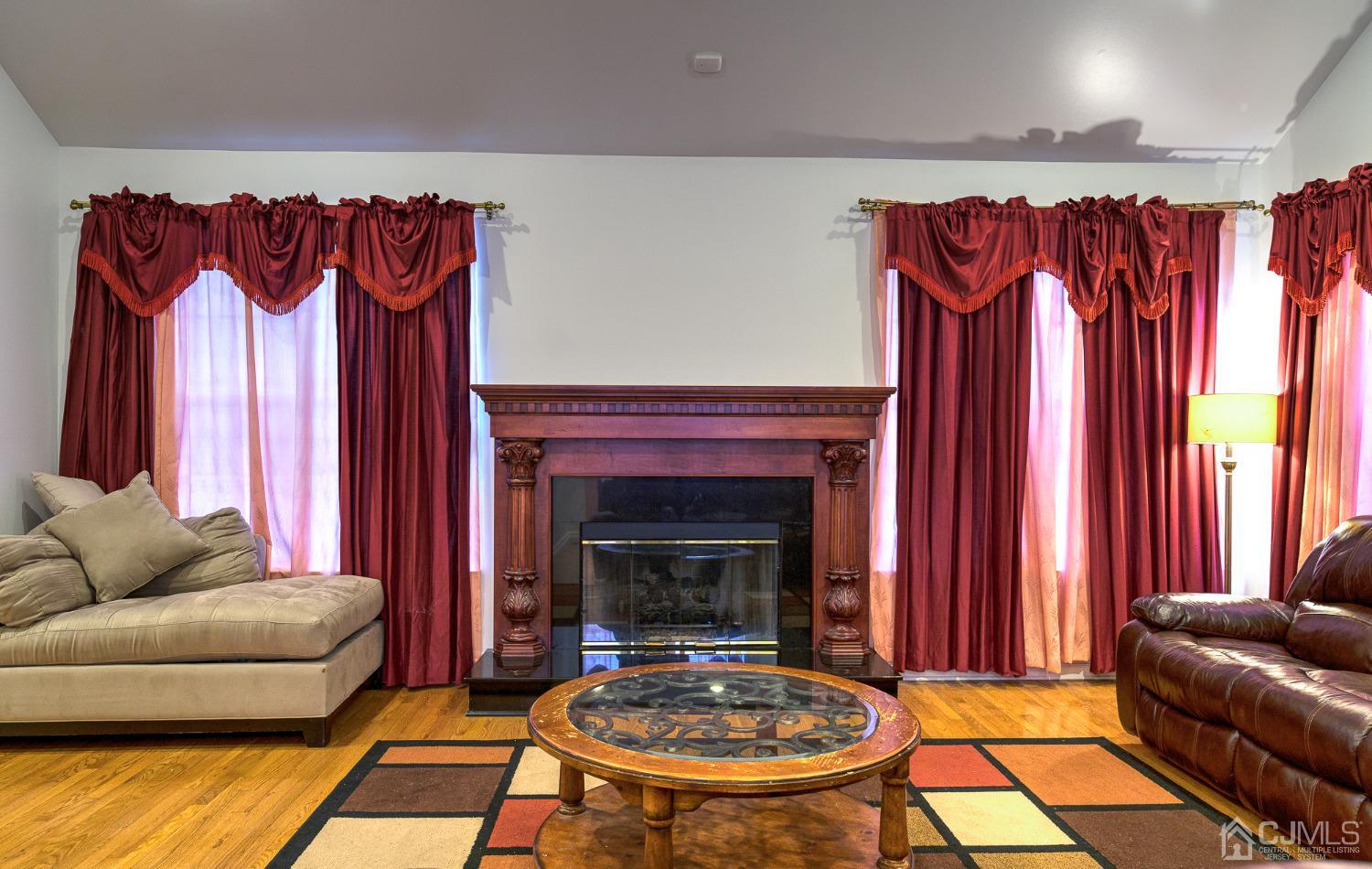 110 Ravine Road Green Brook, NJ 08812 - Photo 3 of 38 a living room with furniture and a fireplace