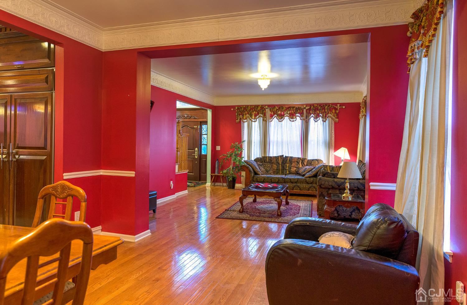 110 Ravine Road Green Brook, NJ 08812 - Photo 6 of 38 a living room with furniture and a chandelier