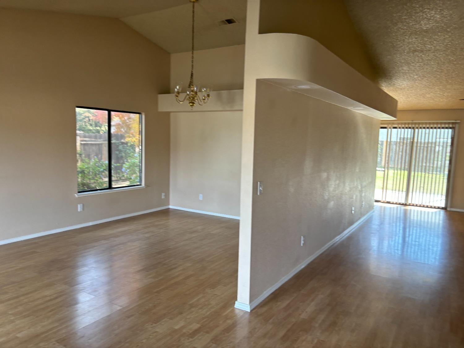 2586 Barstow Avenue Clovis, CA 93611 - Photo 2 of 10 an empty room with wooden floor and windows