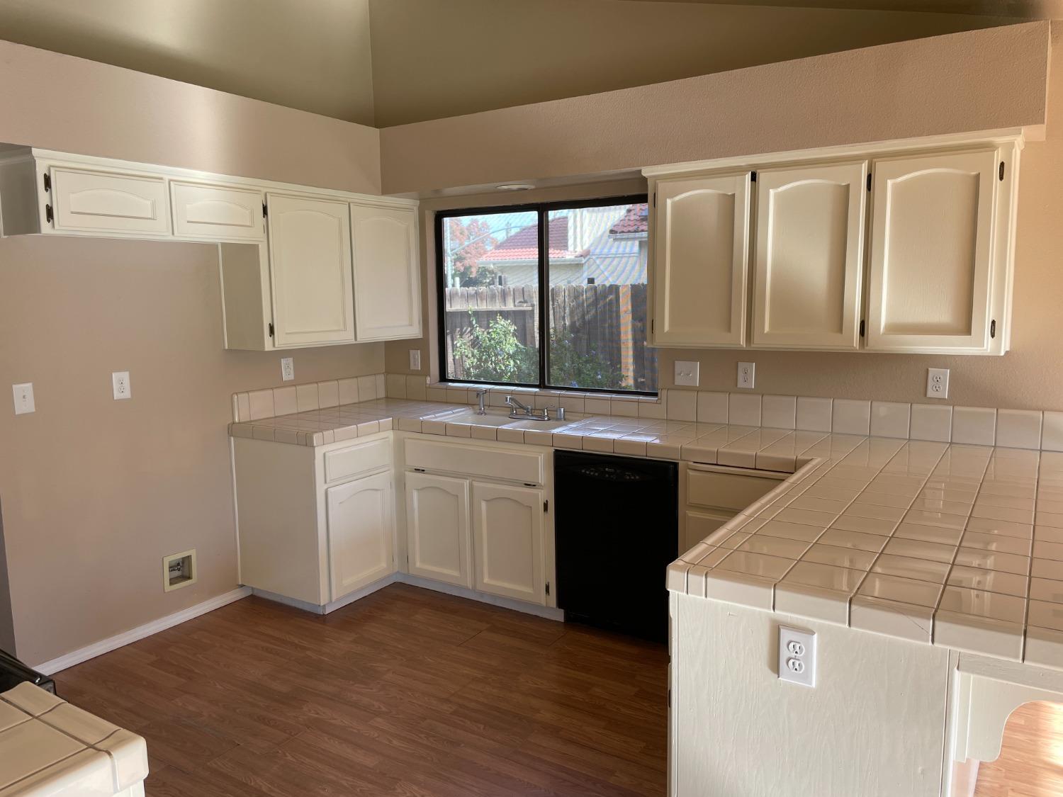 2586 Barstow Avenue Clovis, CA 93611 - Photo 5 of 10 a kitchen with granite countertop white cabinets and white appliances