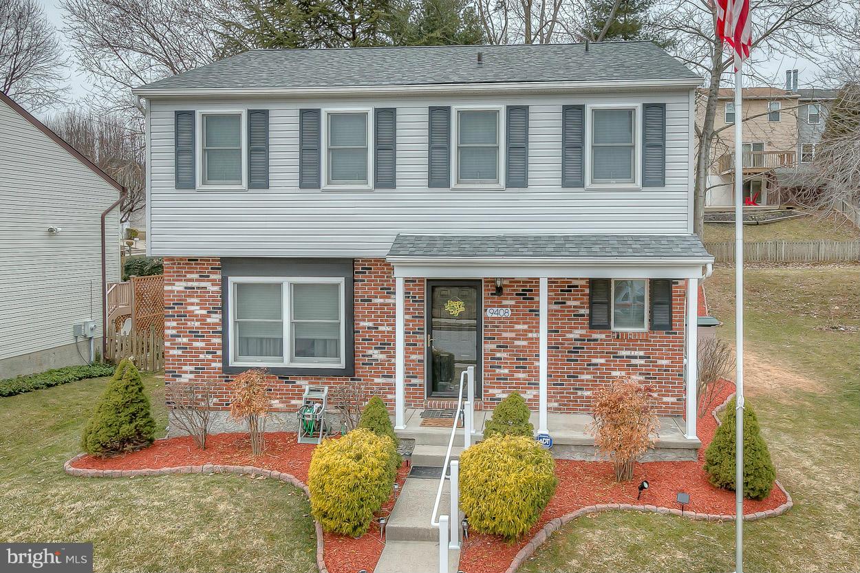 9408 Oak White Road Baltimore, MD 21236 - Photo 1 of 30 front view of a brick house with a yard
