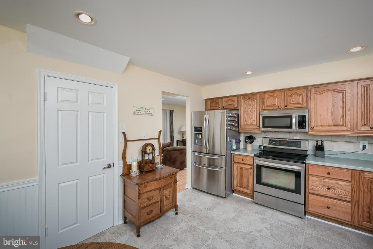 9408 Oak White Road Baltimore, MD 21236 - Photo 13 of 30 a kitchen with stainless steel appliances granite countertop a refrigerator and cabinets