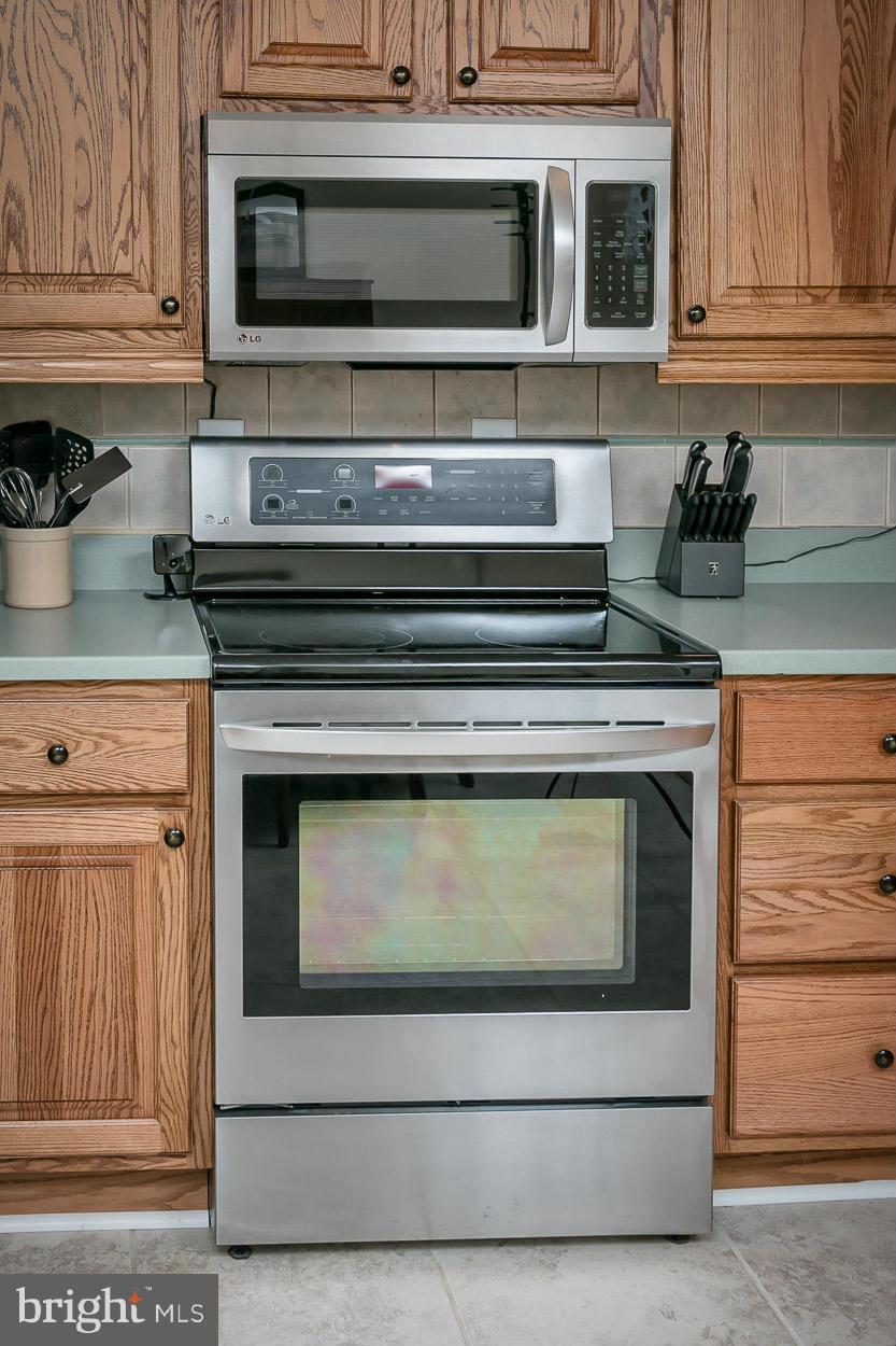 9408 Oak White Road Baltimore, MD 21236 - Photo 14 of 30 a stove top oven sitting inside of a kitchen and granite counter tops