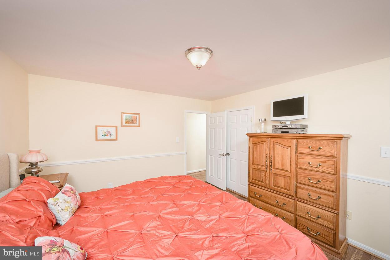9408 Oak White Road Baltimore, MD 21236 - Photo 19 of 30 a bedroom with a bed and a dresser