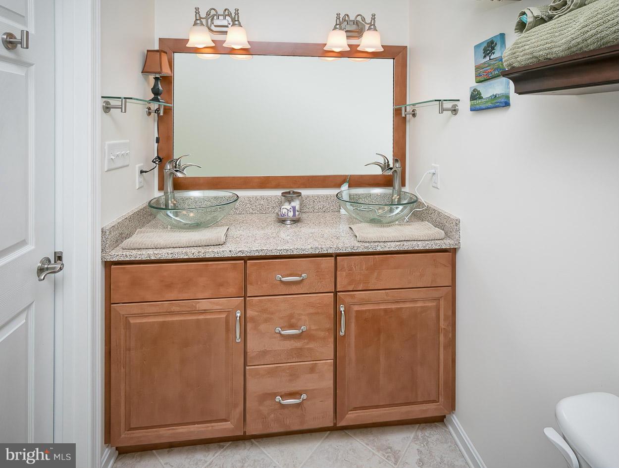 9408 Oak White Road Baltimore, MD 21236 - Photo 21 of 30 a bathroom with a granite countertop sink and a mirror