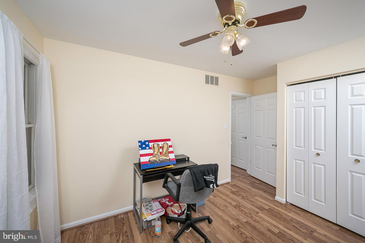 9408 Oak White Road Baltimore, MD 21236 - Photo 28 of 30 a view of a workspace with furniture and wooden floor