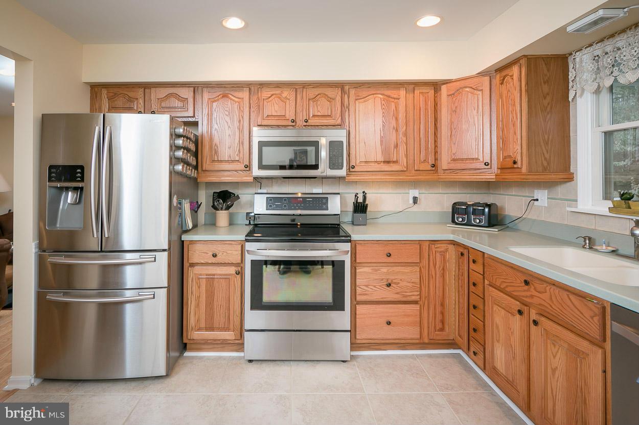 9408 Oak White Road Baltimore, MD 21236 - Photo 9 of 30 a kitchen with stainless steel appliances a refrigerator sink and microwave