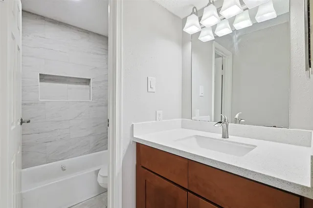 a bathroom with a toilet and a bathtub