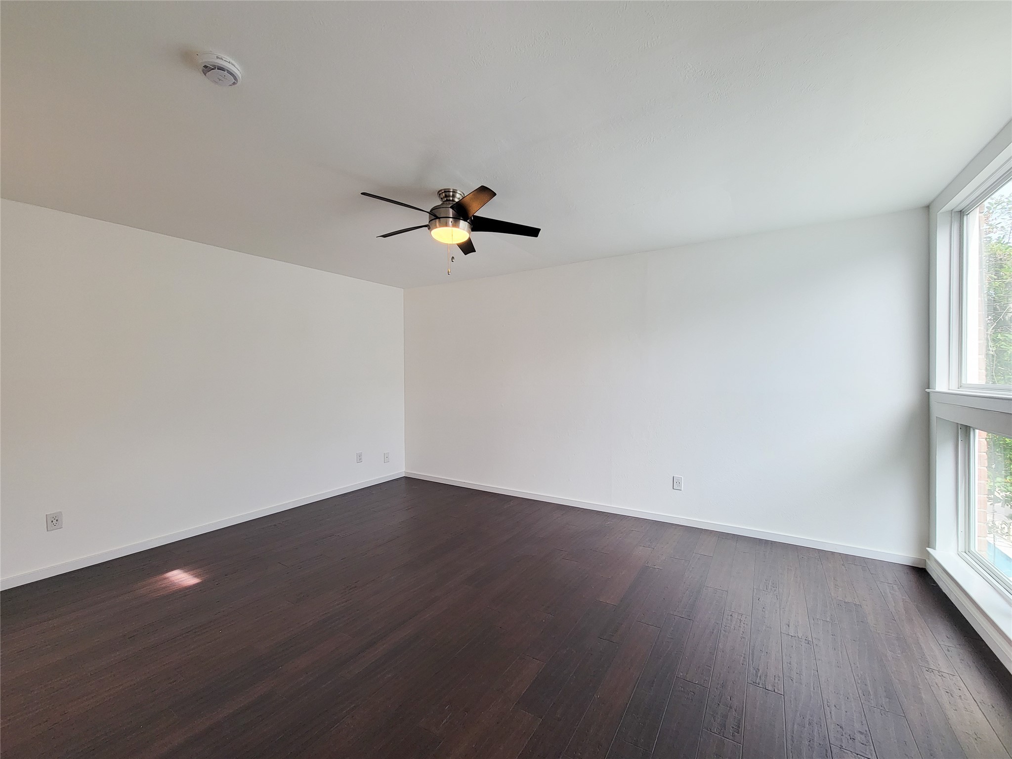 2243 West Alabama Street, Unit B Houston, TX 77098 - Photo 23 of 44 wooden floor in an empty room with a window