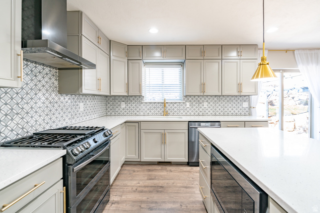 7280 Point Lookout Road Eagle Mountain, UT 84005 - Photo 5 of 26 Kitchen featuring stainless steel appliances, gray cabinets, and light stone counters