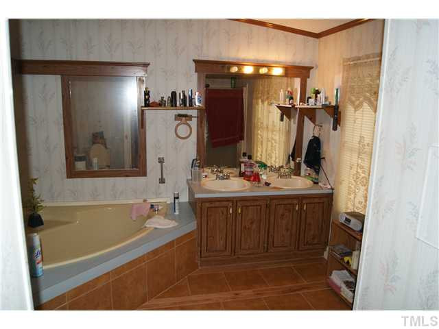 501 Academy Street Raleigh, NC 27603 - Photo 6 of 12 a bathroom with a sink mirror and a bathtub