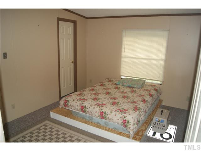 501 Academy Street Raleigh, NC 27603 - Photo 7 of 12 a bedroom with a bed and a window