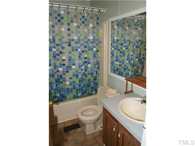 501 Academy Street Raleigh, NC 27603 - Photo 9 of 12 a bathroom with a sink toilet and shower