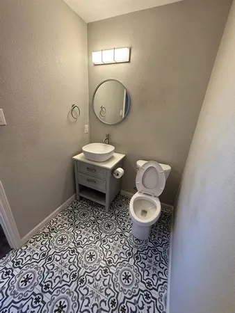 a bathroom with a toilet a sink and a mirror