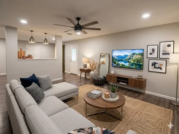 a living room with furniture a rug and a flat screen tv