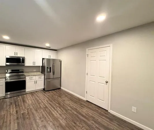 a kitchen with stainless steel appliances a refrigerator and a stove top oven