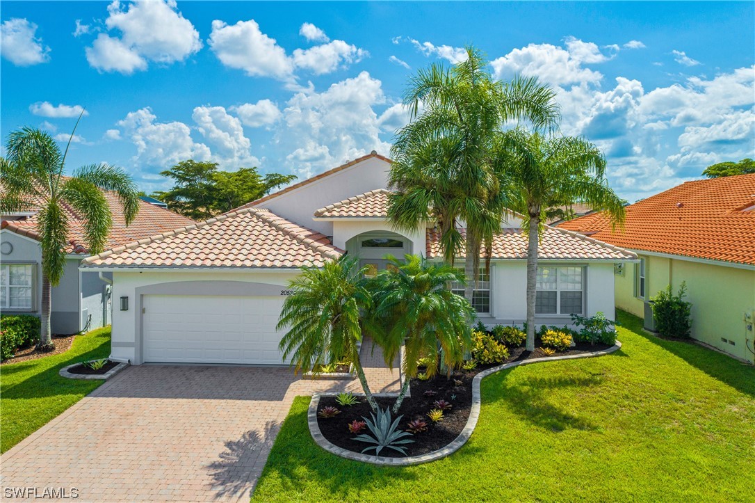 20524 Foxworth Circle Estero, FL 33928 - Photo 1 of 34 a front view of a house with garden