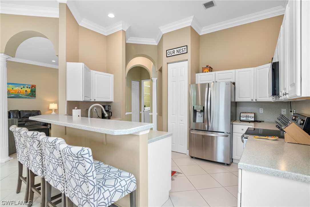 20524 Foxworth Circle Estero, FL 33928 - Photo 14 of 34 a kitchen with stainless steel appliances granite countertop a refrigerator and a stove top oven