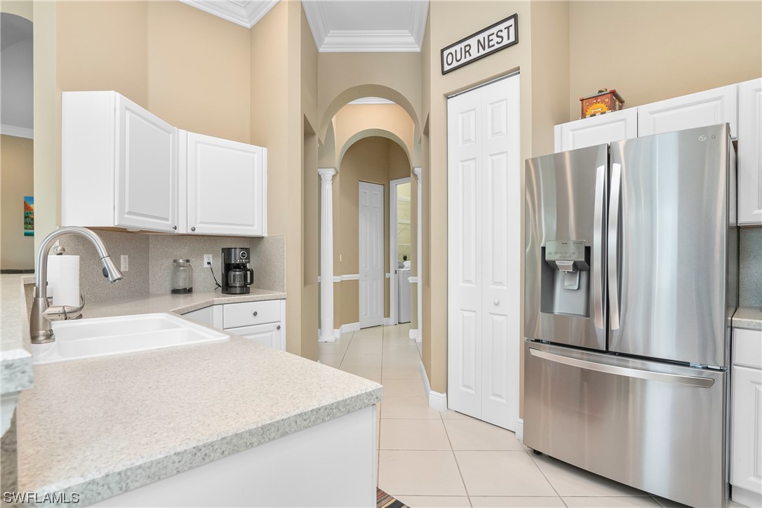 20524 Foxworth Circle Estero, FL 33928 - Photo 16 of 34 a kitchen with stainless steel appliances a refrigerator sink and cabinets
